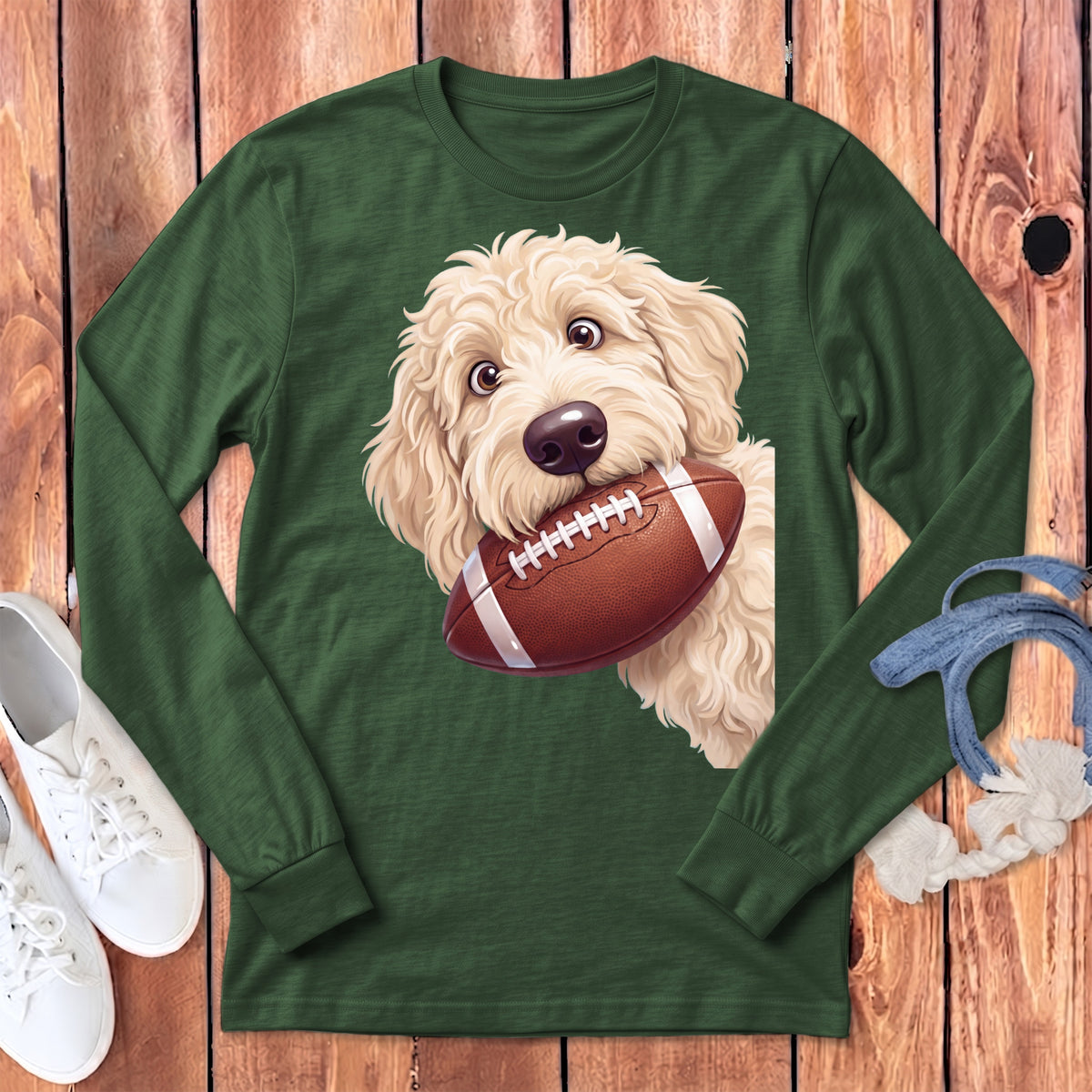 Green long-sleeve shirt with a white doodle dog holding a football.