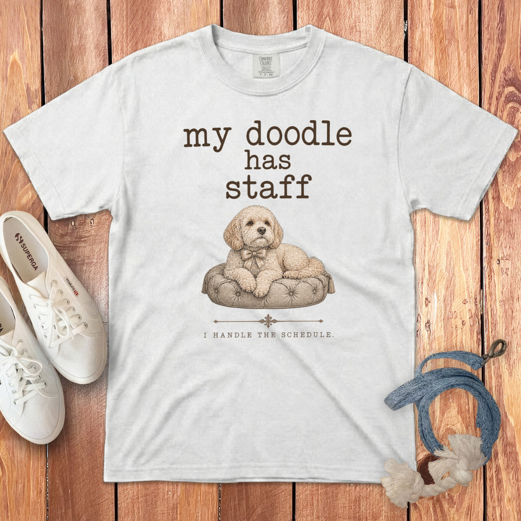 White t-shirt with "my doodle has staff" and a dog on a cushion.