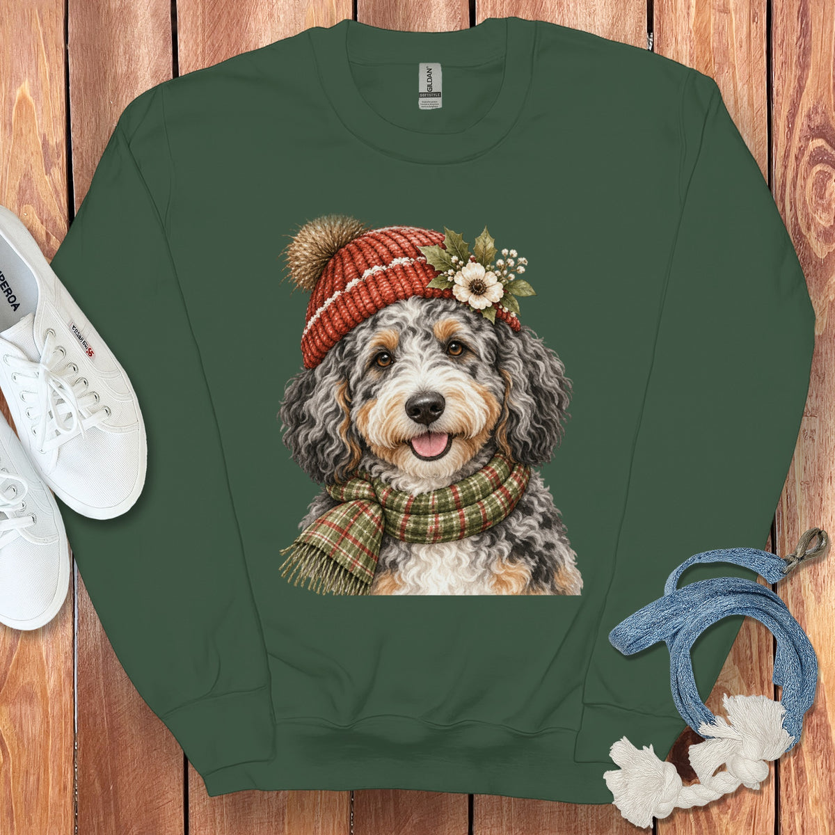 Green sweatshirt with a Bernedoodle dog wearing a Santa hat and scarf.