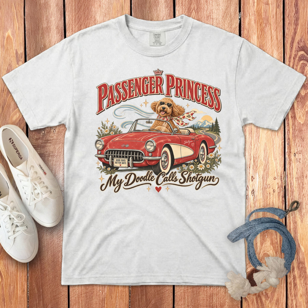White t-shirt graphic with text "Passenger Princess" and a dog driving a convertible.