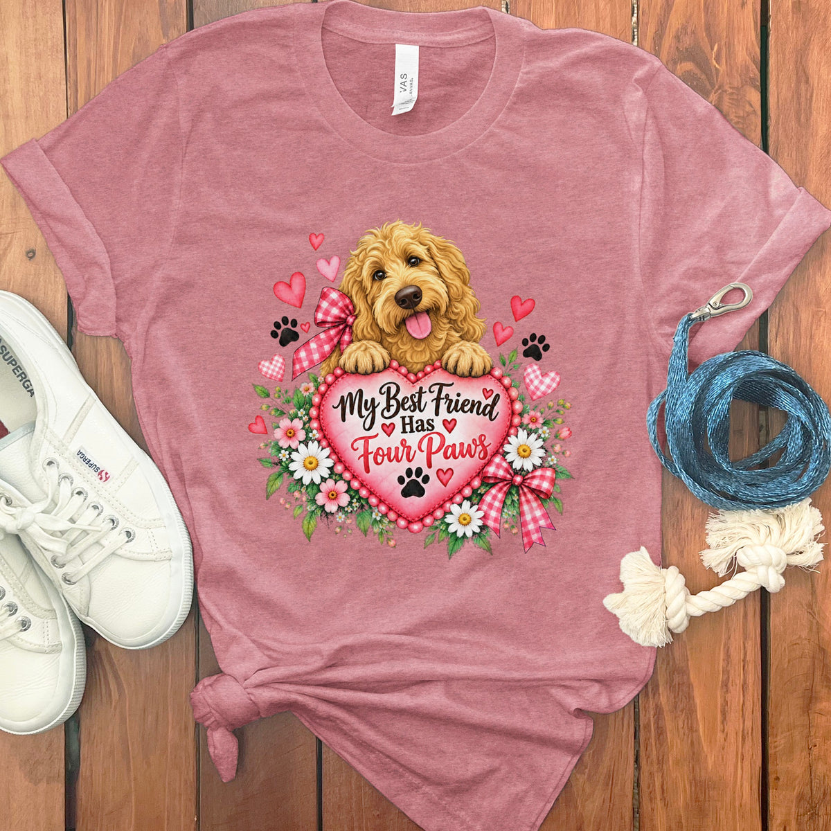 Dusty pink t-shirt featuring a gold doodle dog, flowers, and the text My Best Friend Has Four Paws.