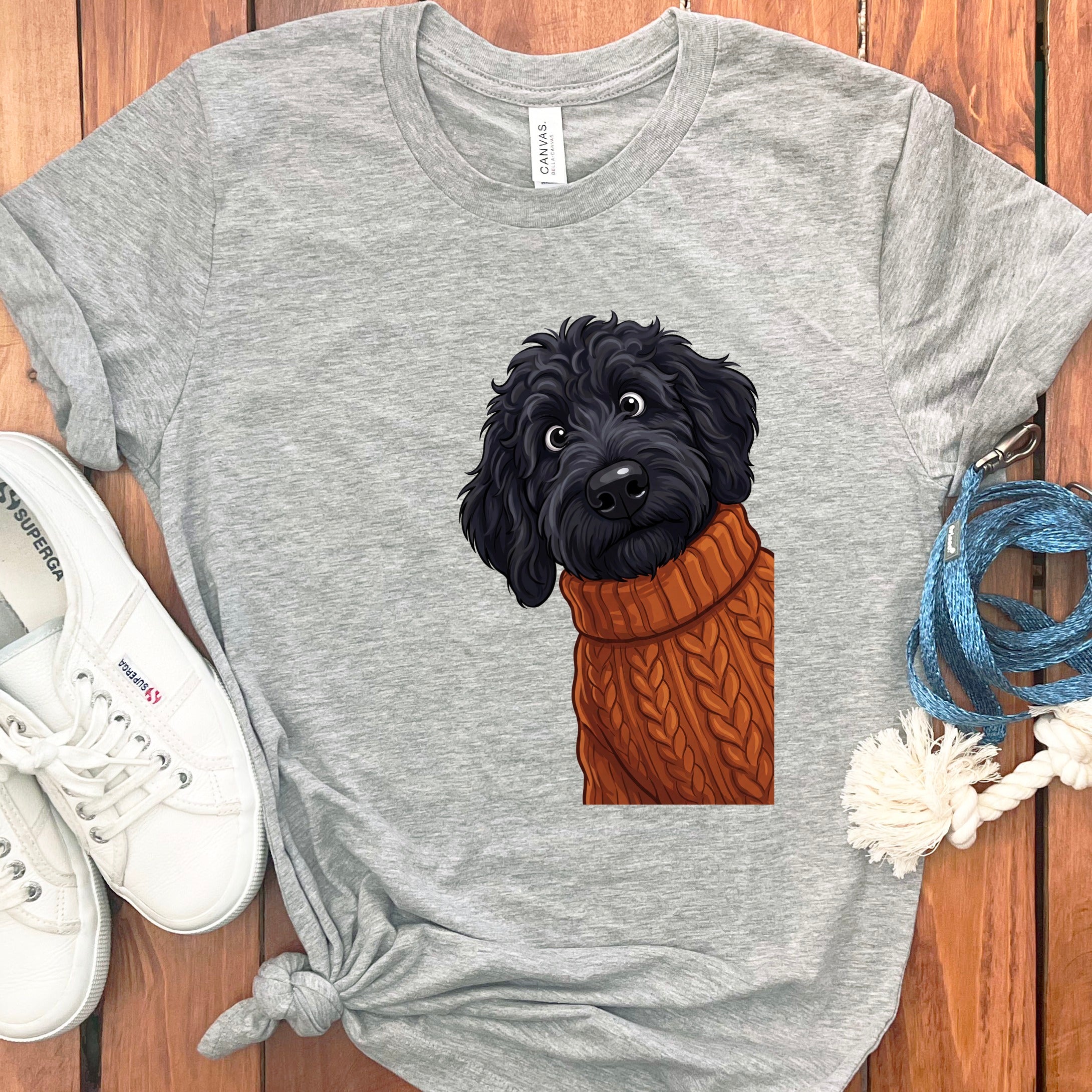 Gray t-shirt with a black dog wearing an orange knit sweater graphic.