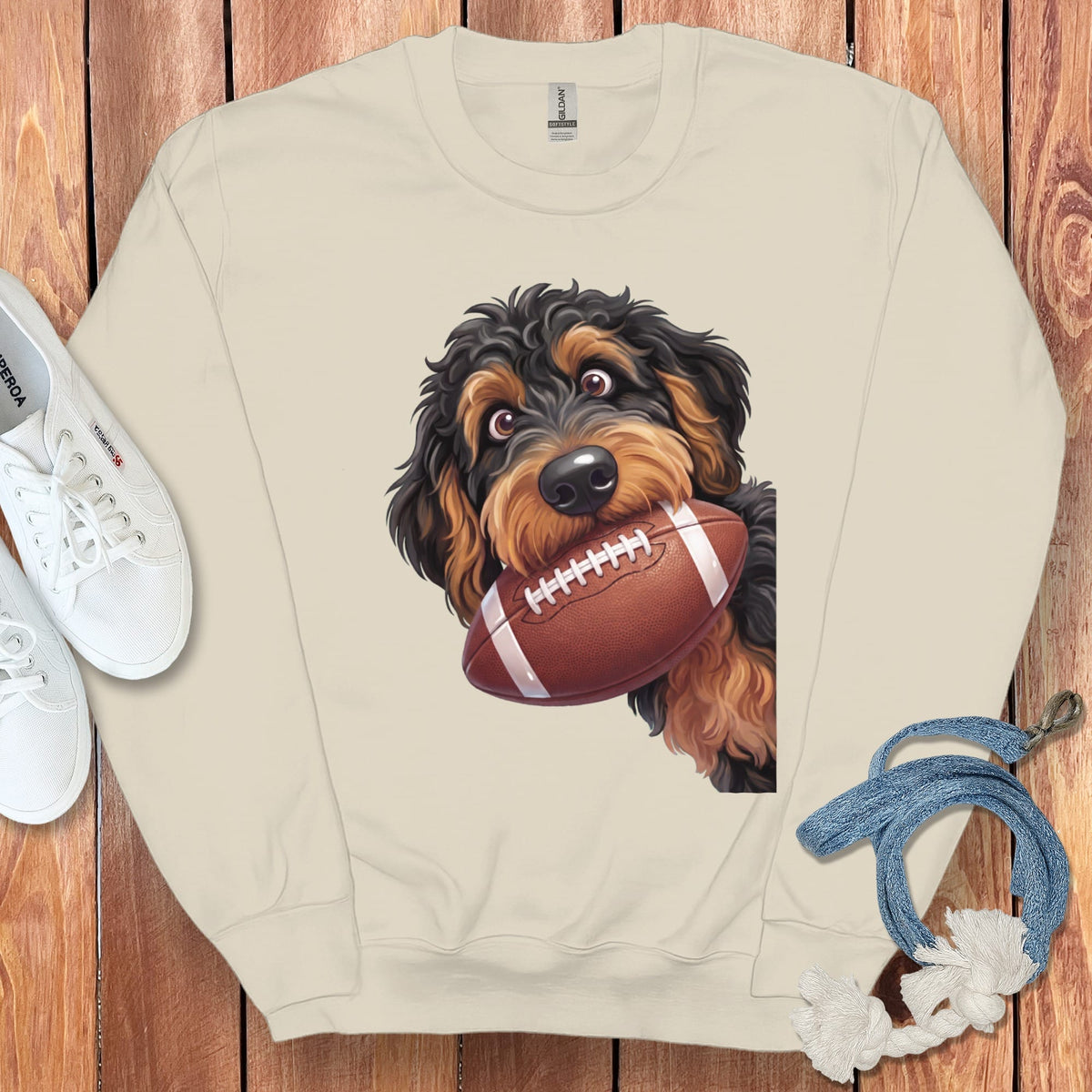 Beige sweatshirt with a cartoon dog holding a football.