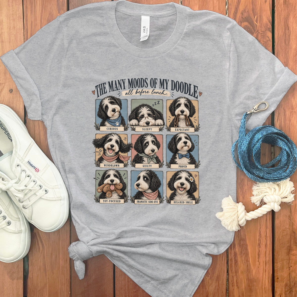 Gray t-shirt with nine panels of a doodle dog displaying different moods and text.