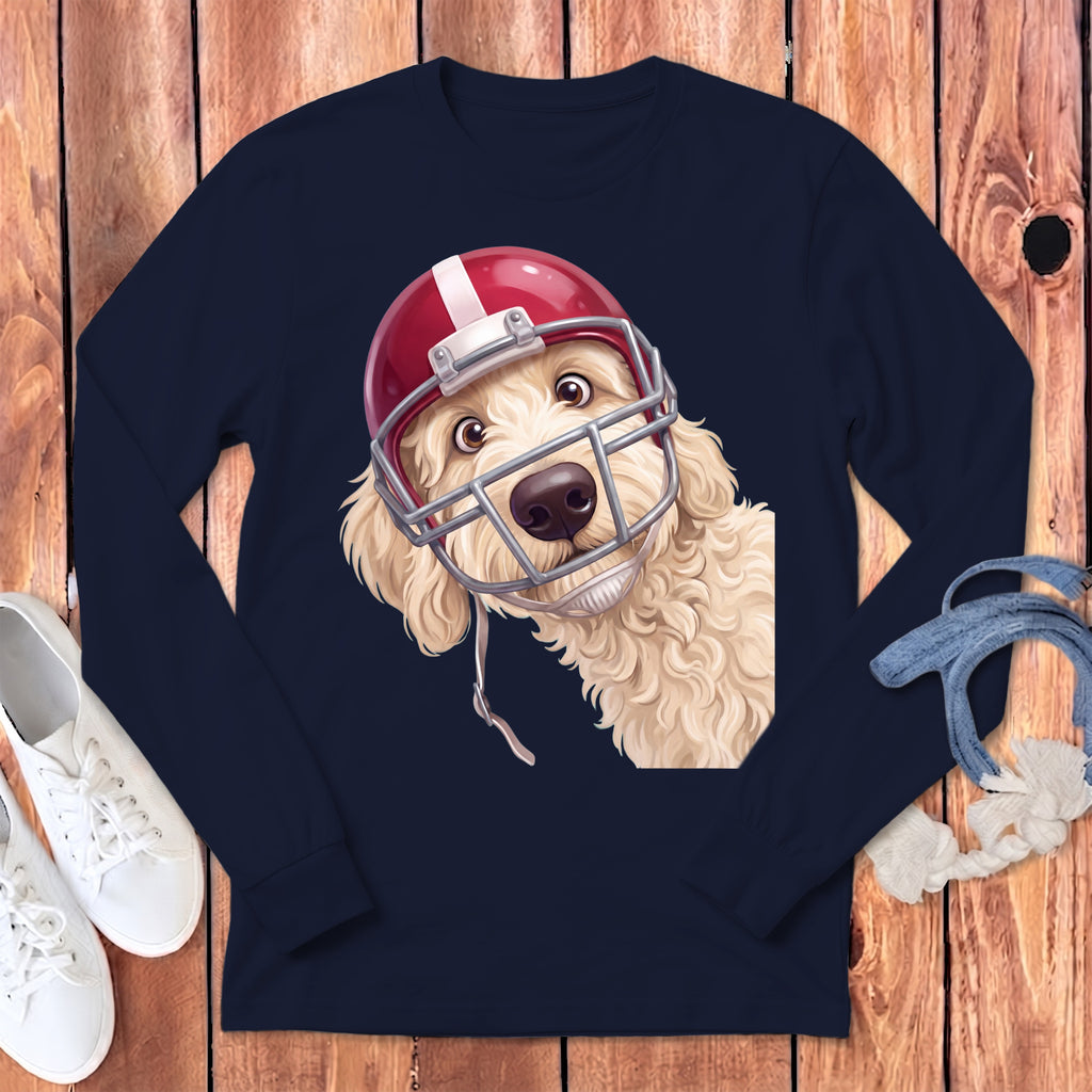 Golden doodle dog wearing a red and white football helmet on a navy t-shirt.