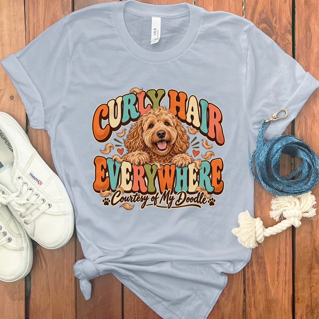 Light blue t-shirt with dog graphic and text: "Curly Hair Everywhere Courtesy of My Doodle."