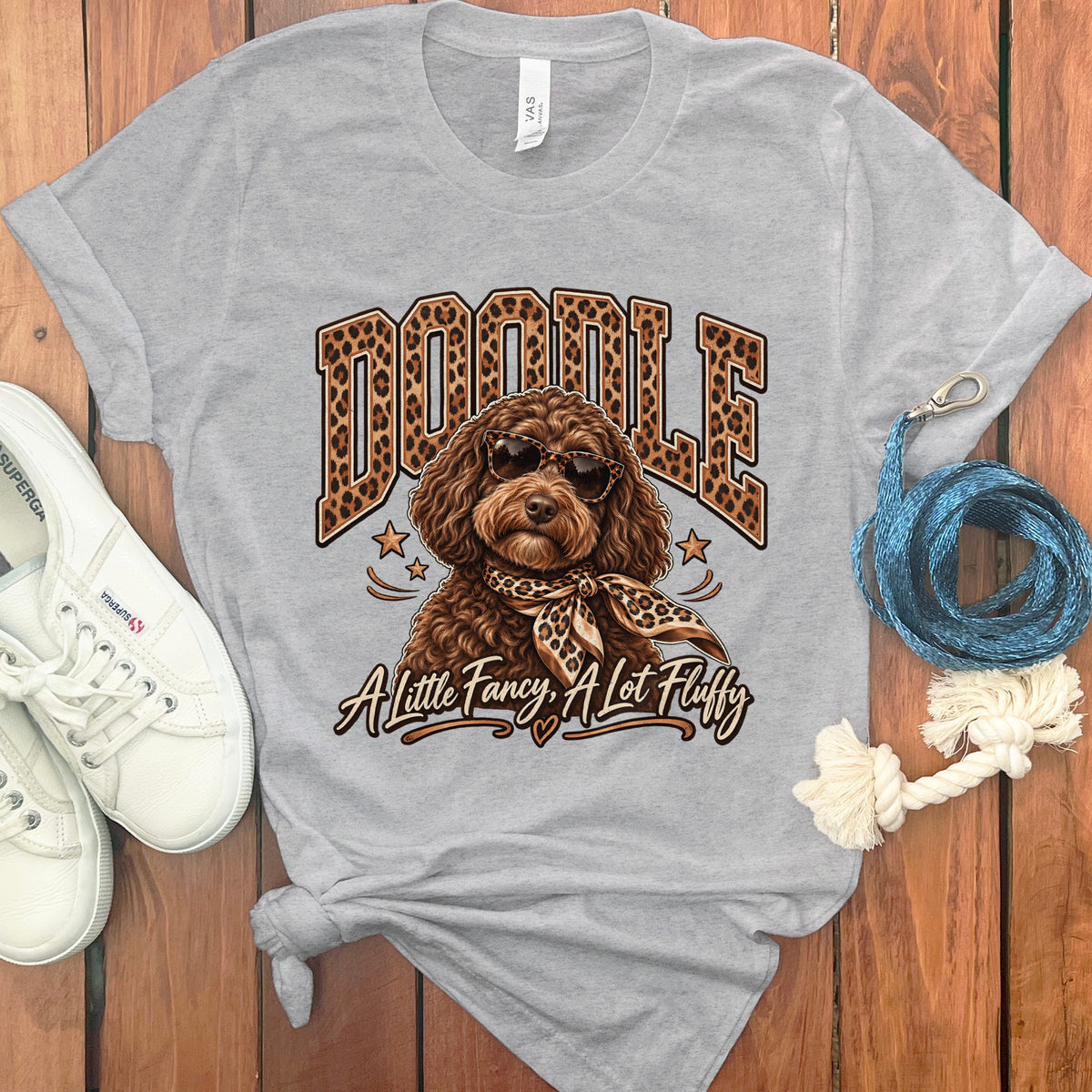 T-shirt with a brown doodle dog wearing sunglasses and a leopard print scarf.