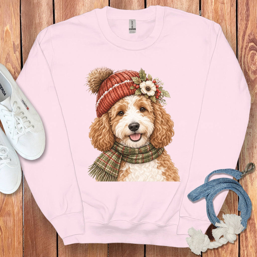 Pink sweatshirt with a doodle dog wearing a winter hat and scarf graphic.