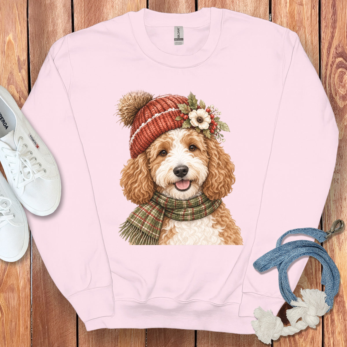 Pink sweatshirt with a doodle dog wearing a winter hat and scarf graphic.