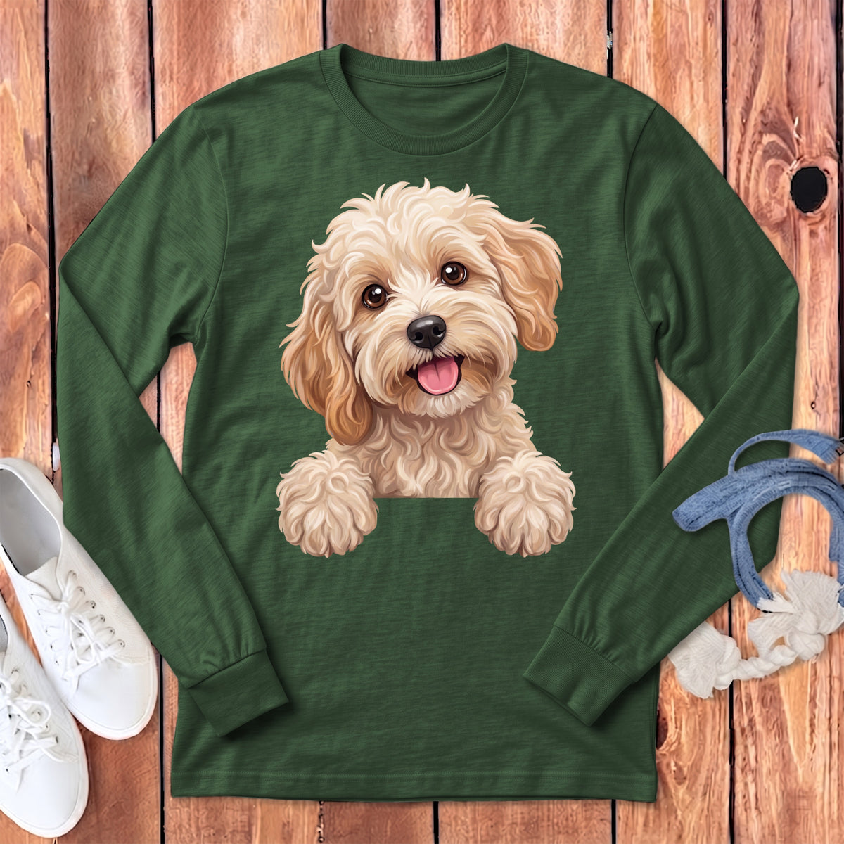 Long sleeve green t-shirt with a fluffy cream colored dog illustration.