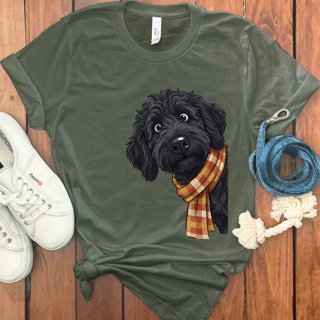 Green t-shirt with a black dog wearing a plaid scarf graphic.