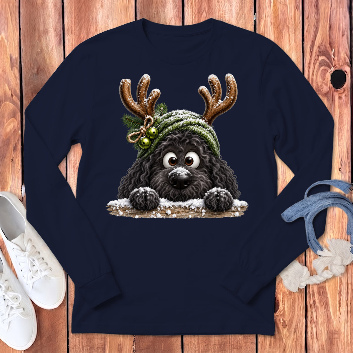 Black dog wearing reindeer antlers and a green hat with snow.