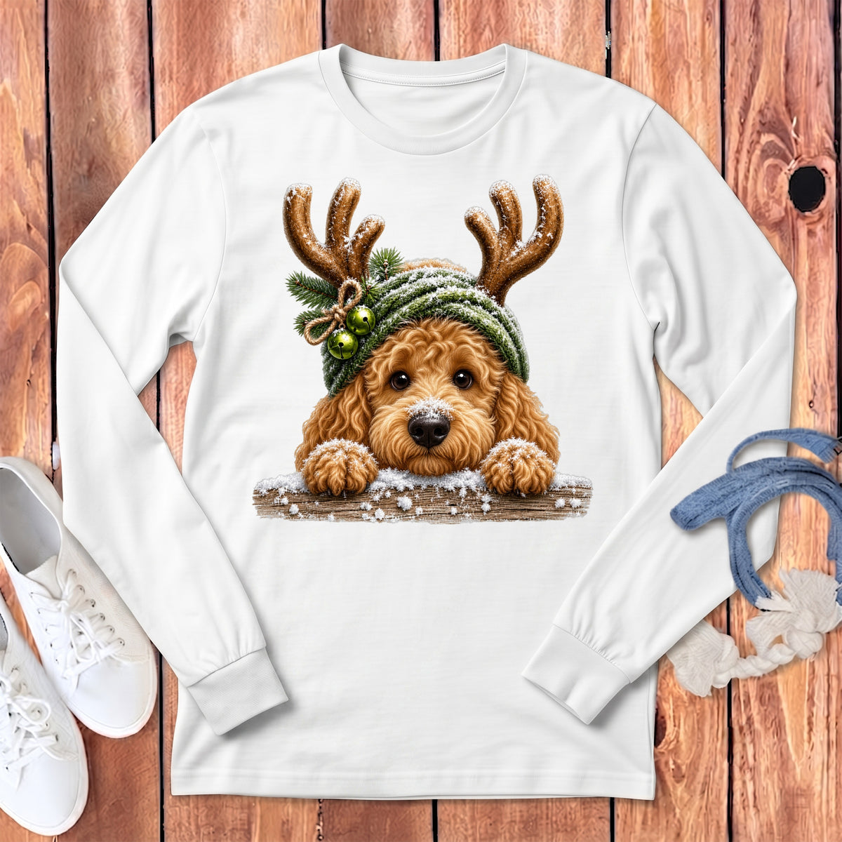 White long-sleeve shirt with a golden doodle wearing a green reindeer hat and antlers.