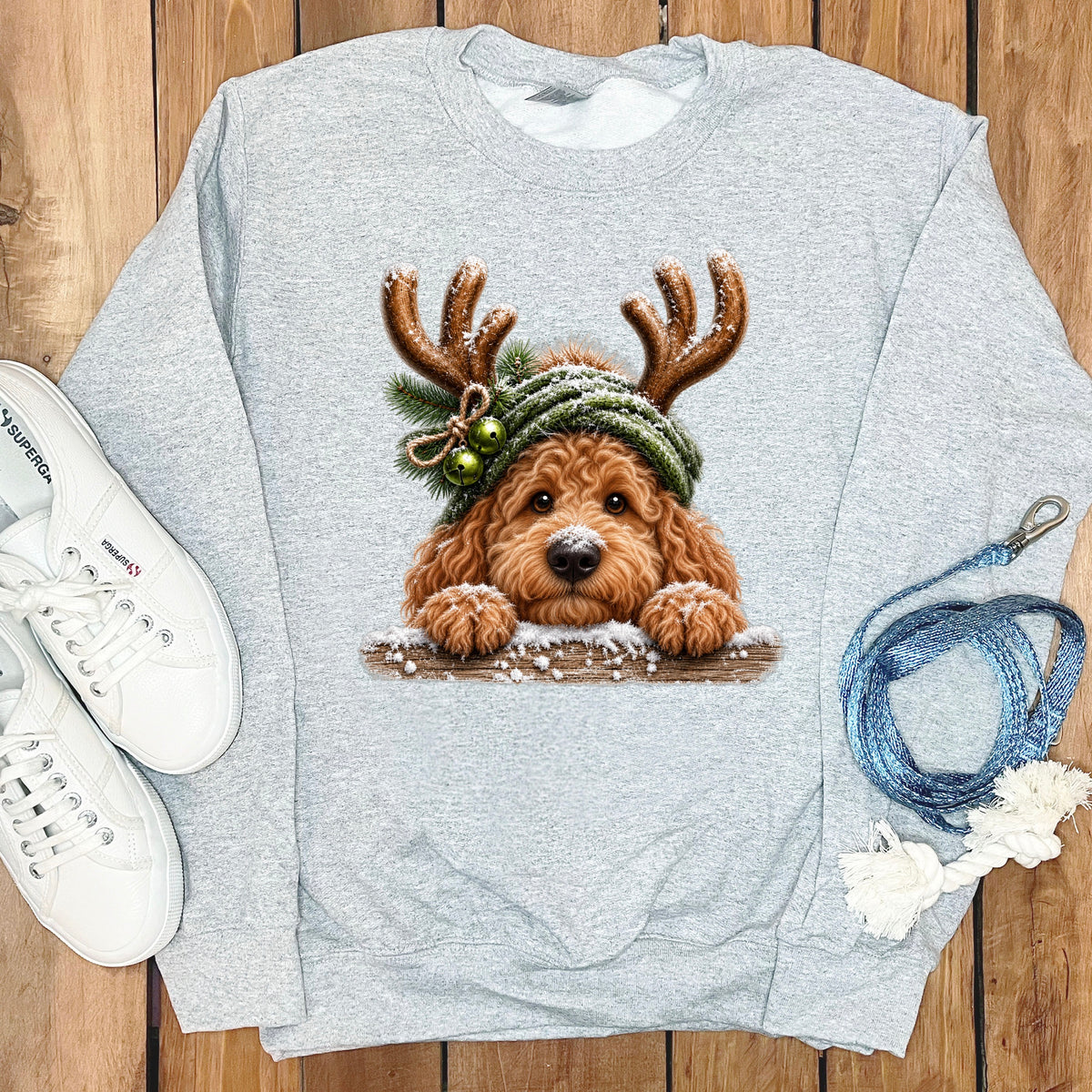 Light grey sweatshirt featuring a festive doodle dog graphic wearing antlers and a hat.