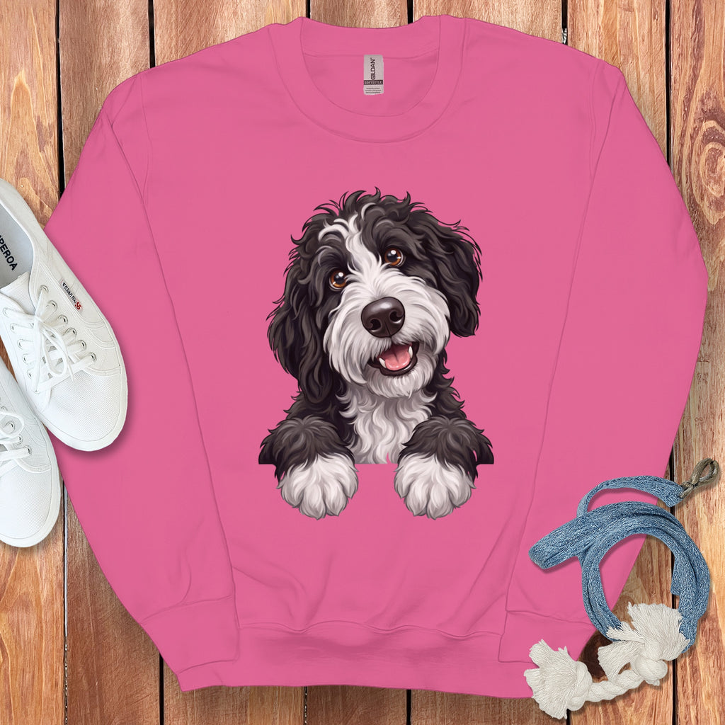 Pink sweatshirt with a black and white fluffy dog illustration.