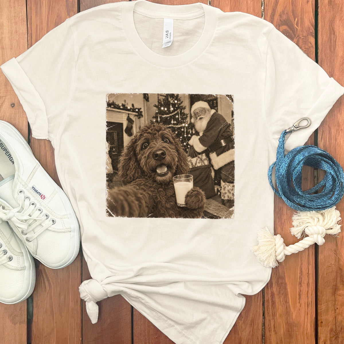 Off-white crewneck t-shirt featuring a vintage graphic of a brown doodle holding milk with Santa Claus in the background.