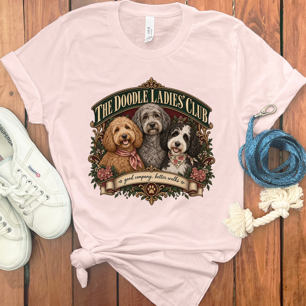 The Doodle Ladies Club t-shirt features three doodle dogs and "good company, better walks" text.