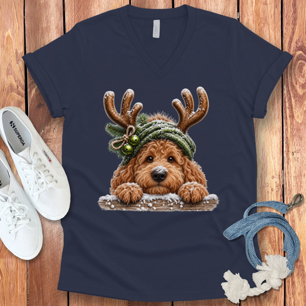 Dog wearing reindeer antlers and a green hat, with snow.