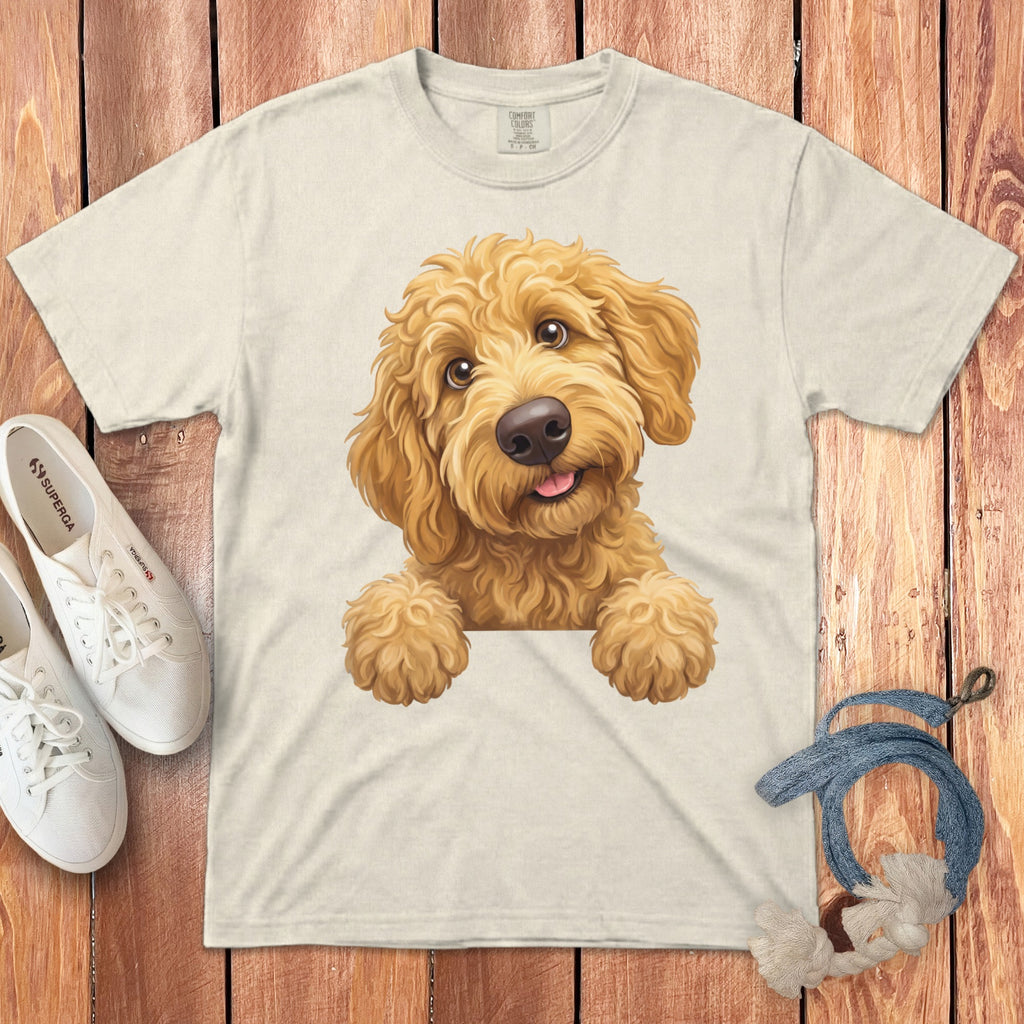 Cream t-shirt with a playful golden doodle dog graphic peeking over the hem.