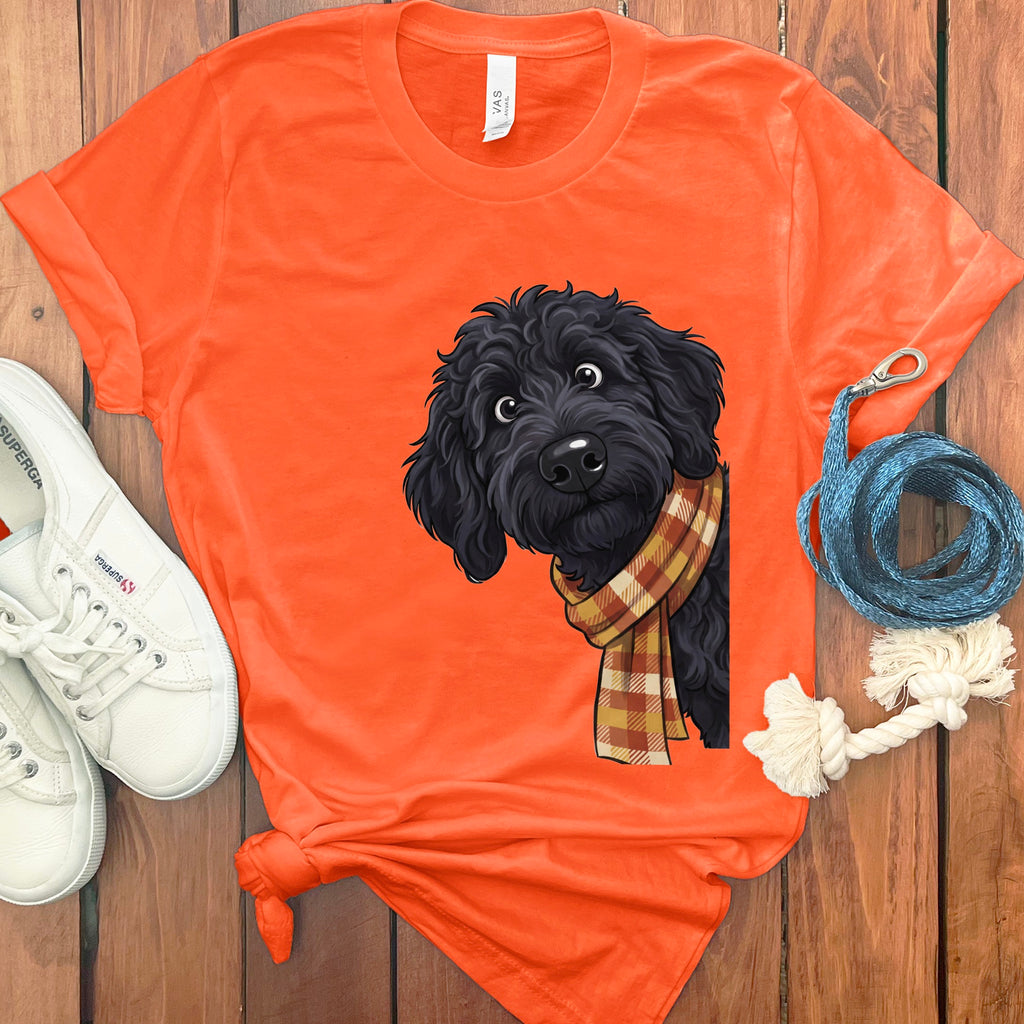 Orange t-shirt with a black doodle dog graphic wearing a plaid scarf.