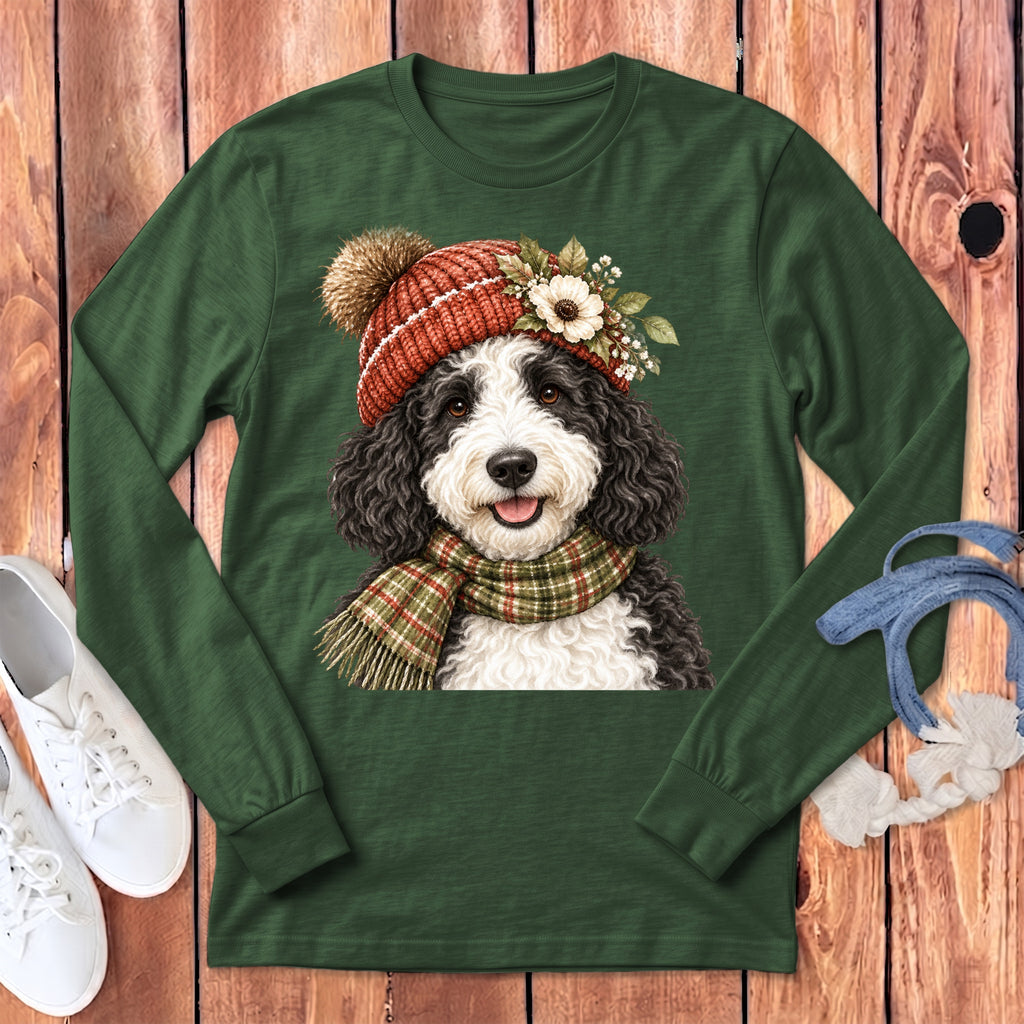 Green long-sleeve shirt with a black and white dog wearing a knit hat and scarf.
