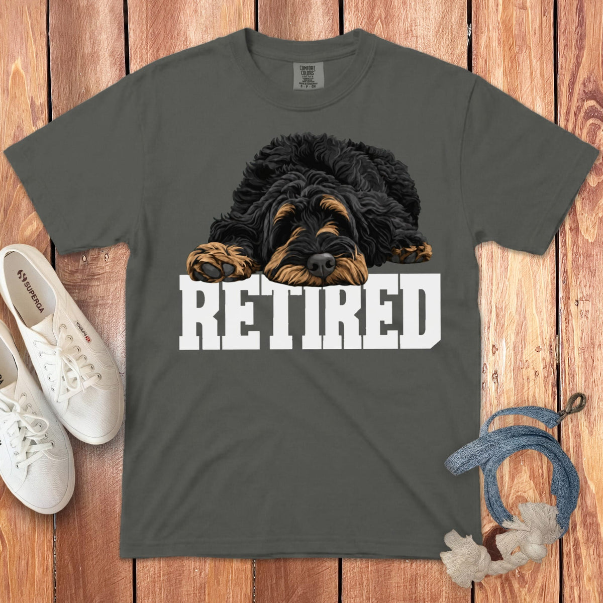 T-shirt with a sleepy, shaggy dog graphic and the word "RETIRED" in bold white letters.