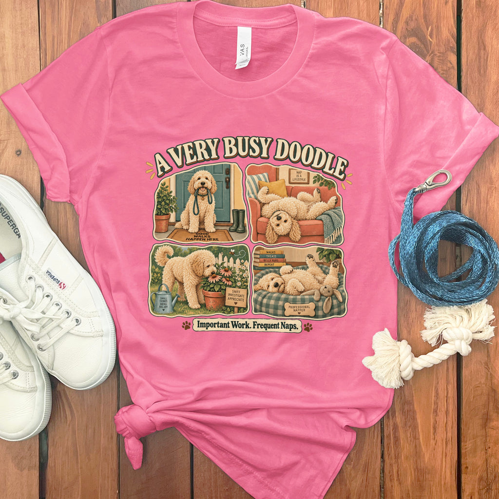 Pink t-shirt with "A VERY BUSY DOODLE" and four cartoon dog scenes.