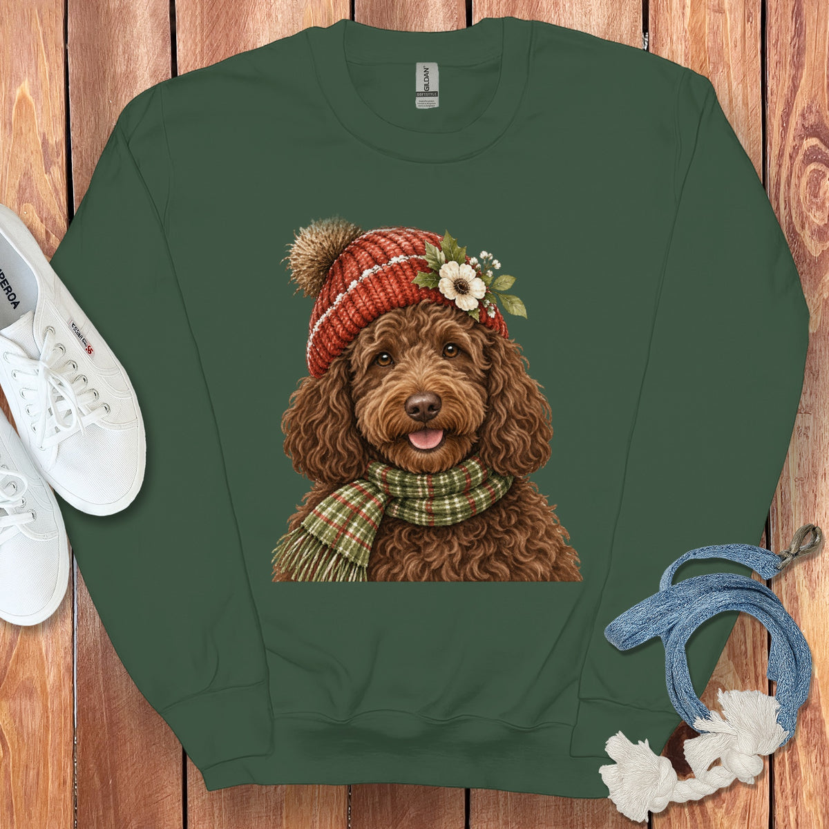 Green sweatshirt featuring a brown doodle dog wearing a red beanie and scarf.