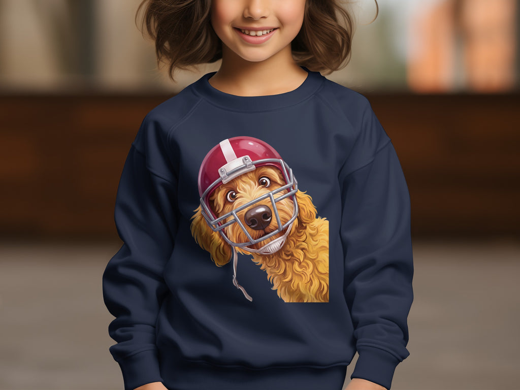 Golden doodle dog wearing a red football helmet on a navy sweatshirt.