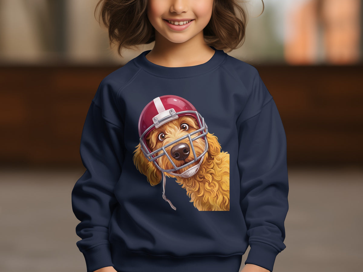 Golden doodle dog wearing a red football helmet on a navy sweatshirt.