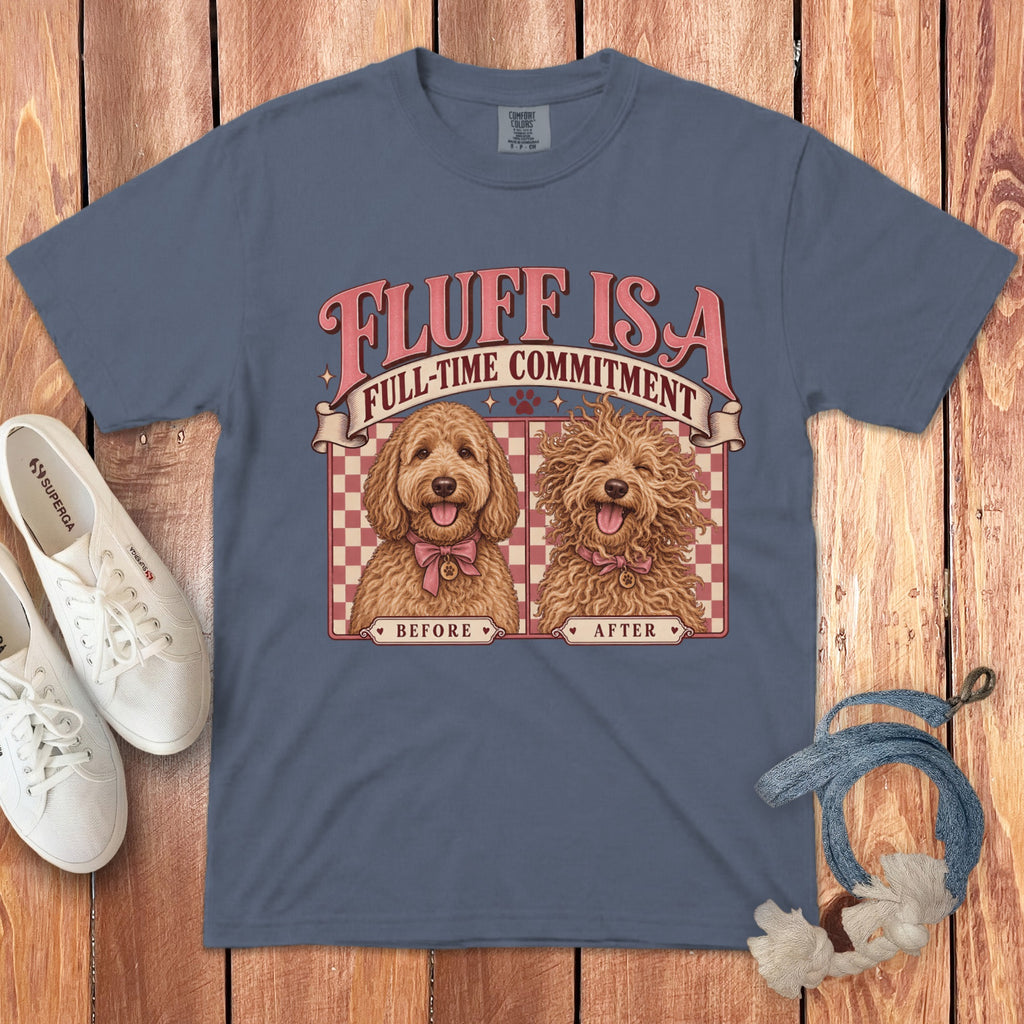 A gray t-shirt with a graphic of two labradoodles labeled "before" and "after" resting on a wooden background.