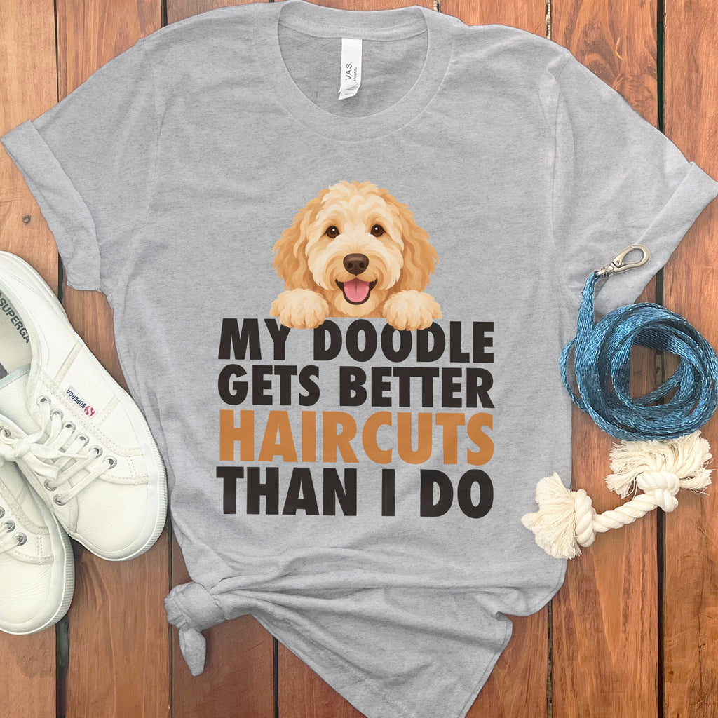 Grey t-shirt with cartoon doodle and text "MY DOODLE GETS BETTER HAIRCUTS THAN I DO".
