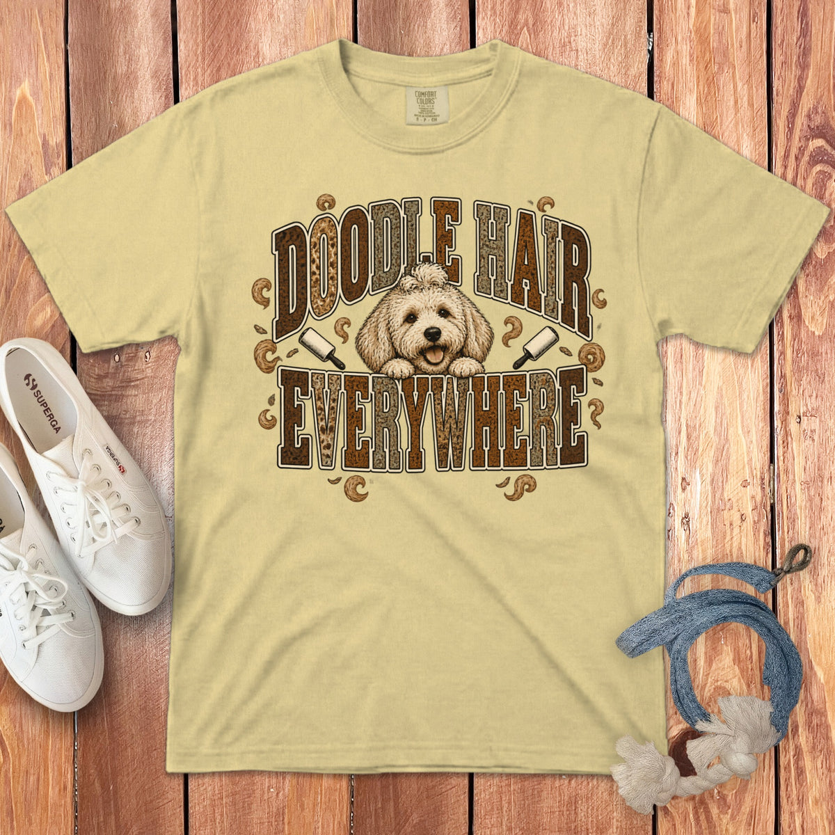 Light yellow graphic t-shirt featuring a doodle dog illustration and the text "Doodle Hair Everywhere."