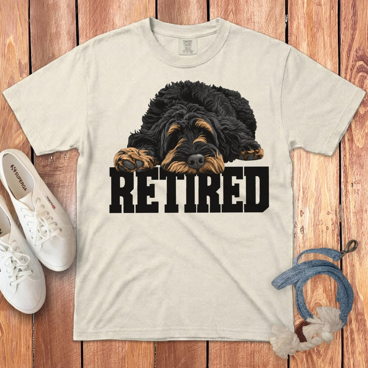 Cream t-shirt with a black and tan dog and the word "RETIRED" on the front.