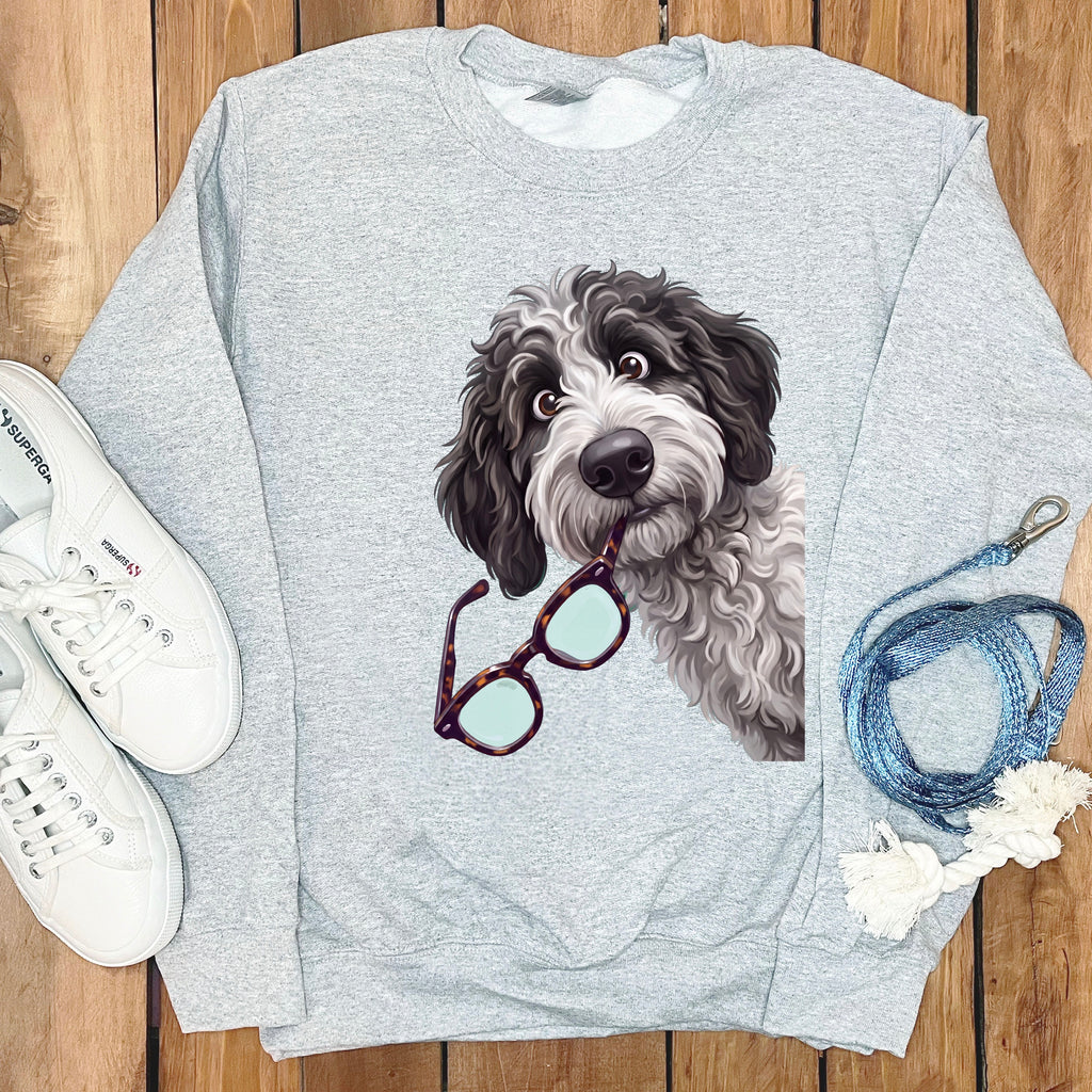 Gray crewneck sweatshirt featuring a graphic of a shaggy doodle dog holding tortoise shell glasses.
