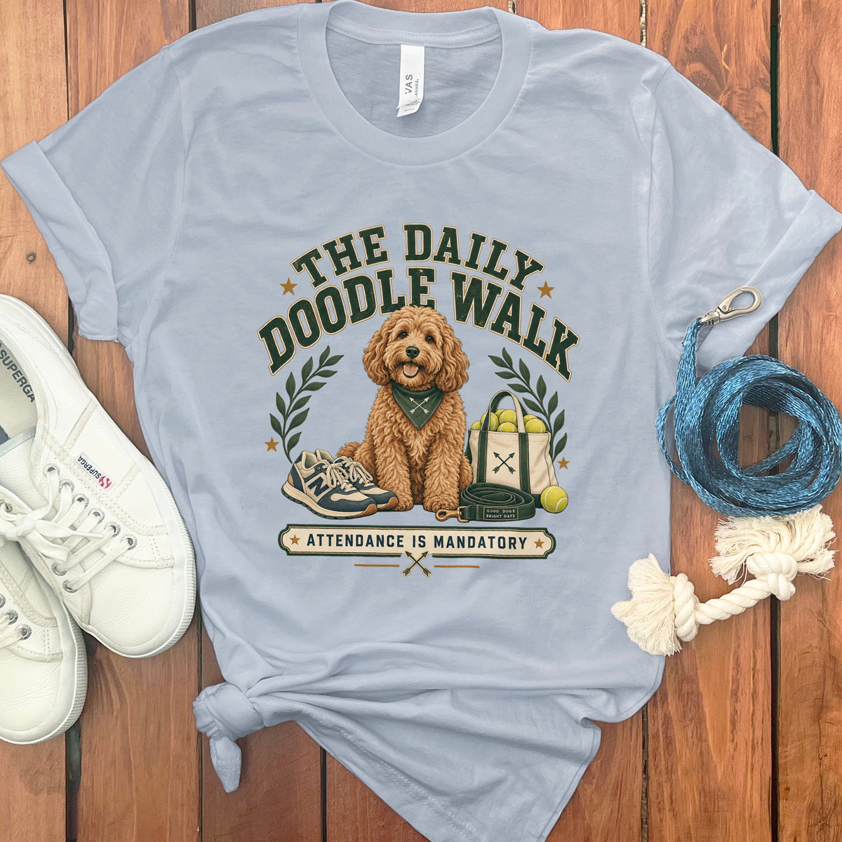 Light blue t-shirt with dog graphic: "The Daily Doodle Walk. Attendance Is Mandatory."