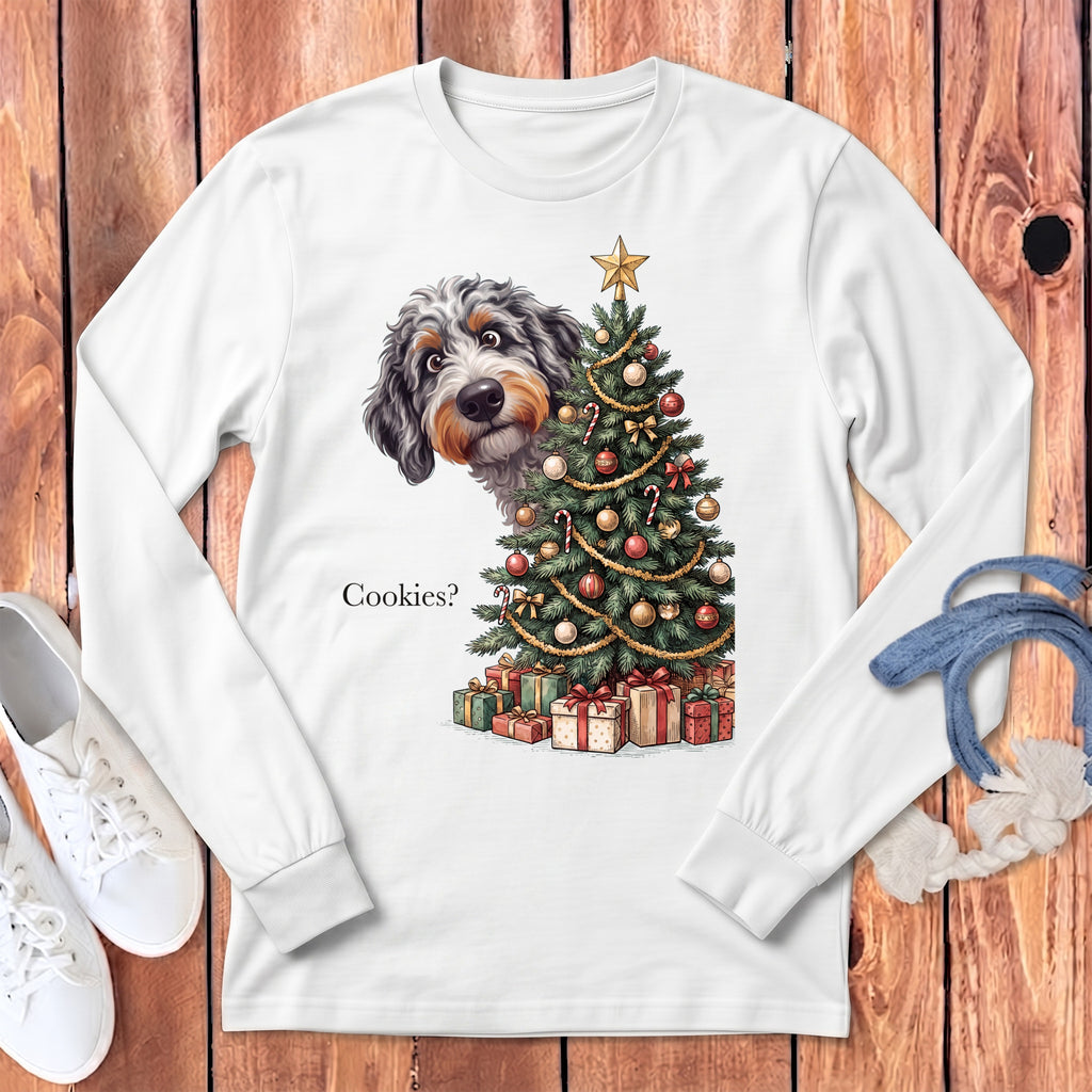Dog peeking behind Christmas tree with presents, text "Cookies?".