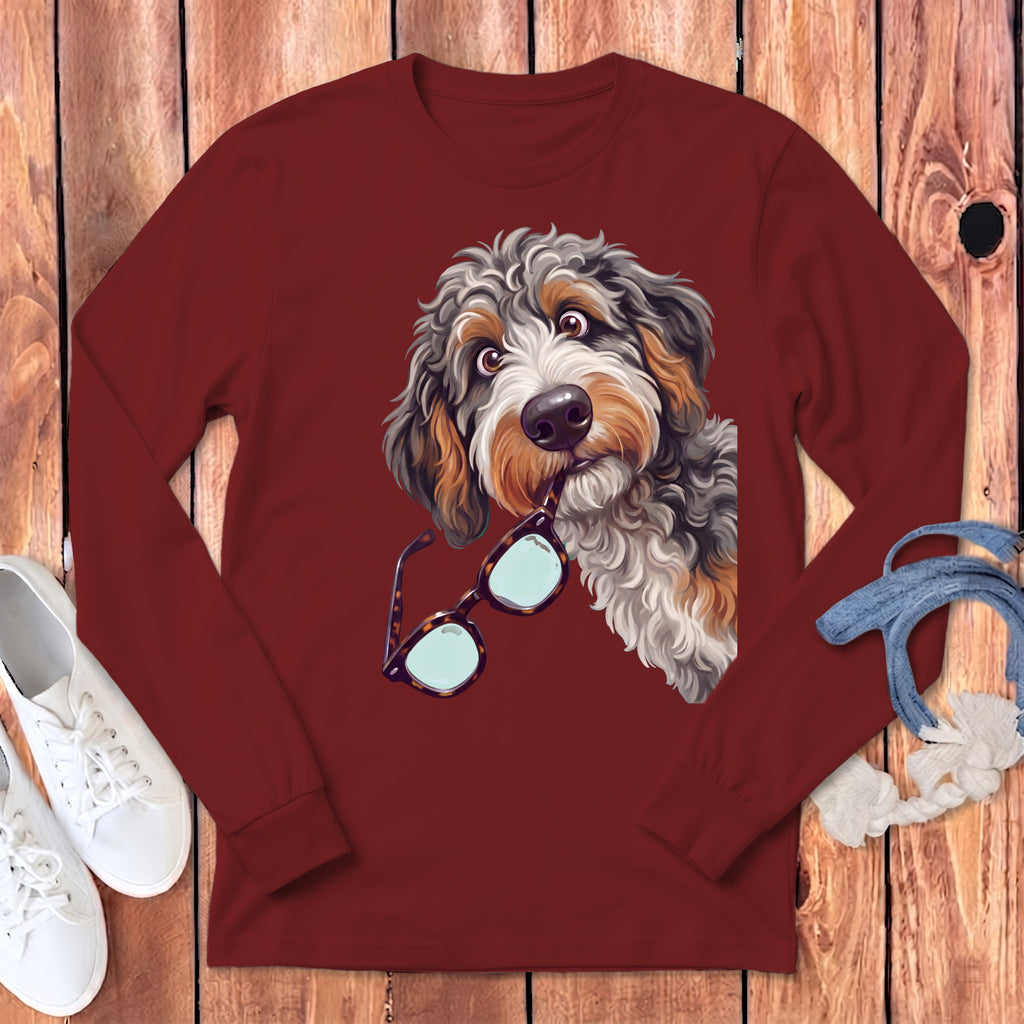 Maroon long-sleeved shirt featuring a graphic of a fluffy dog holding glasses in its mouth.