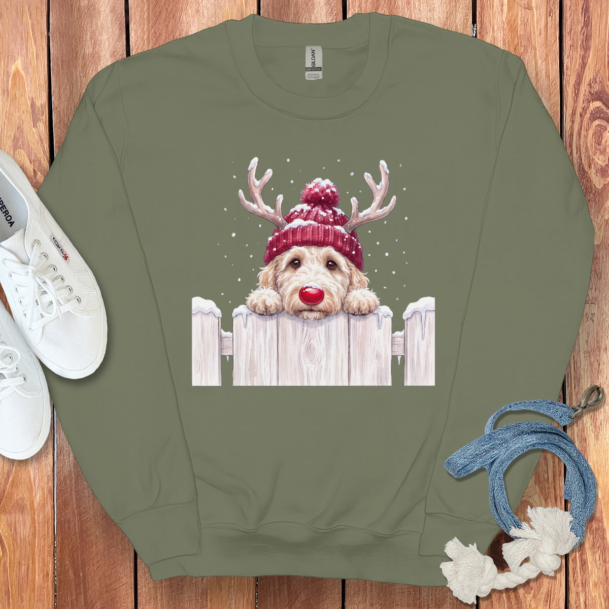 Crewneck sweatshirt with a doodle dog wearing a red beanie and antlers.
