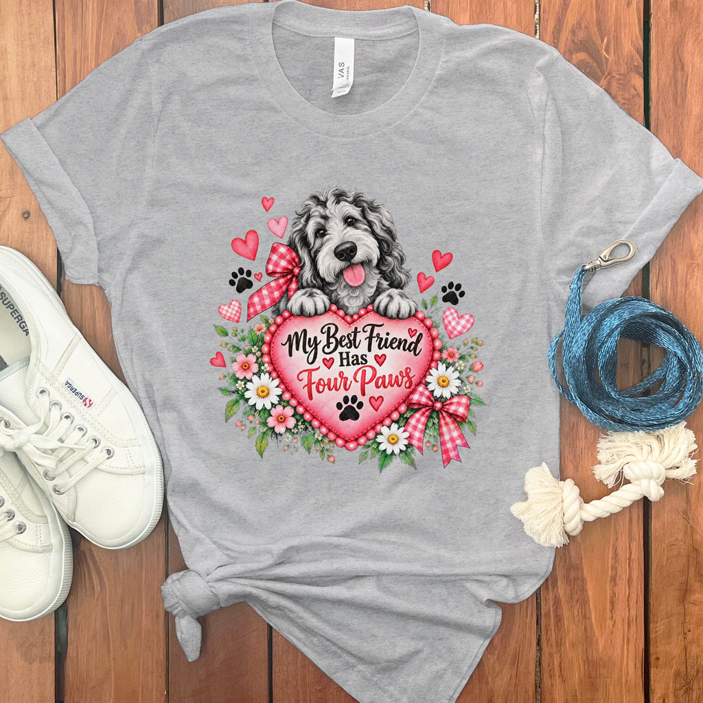 Heather gray t-shirt with a graphic of a dog, a pink heart, flowers, and the text My Best Friend Has Four Paws.