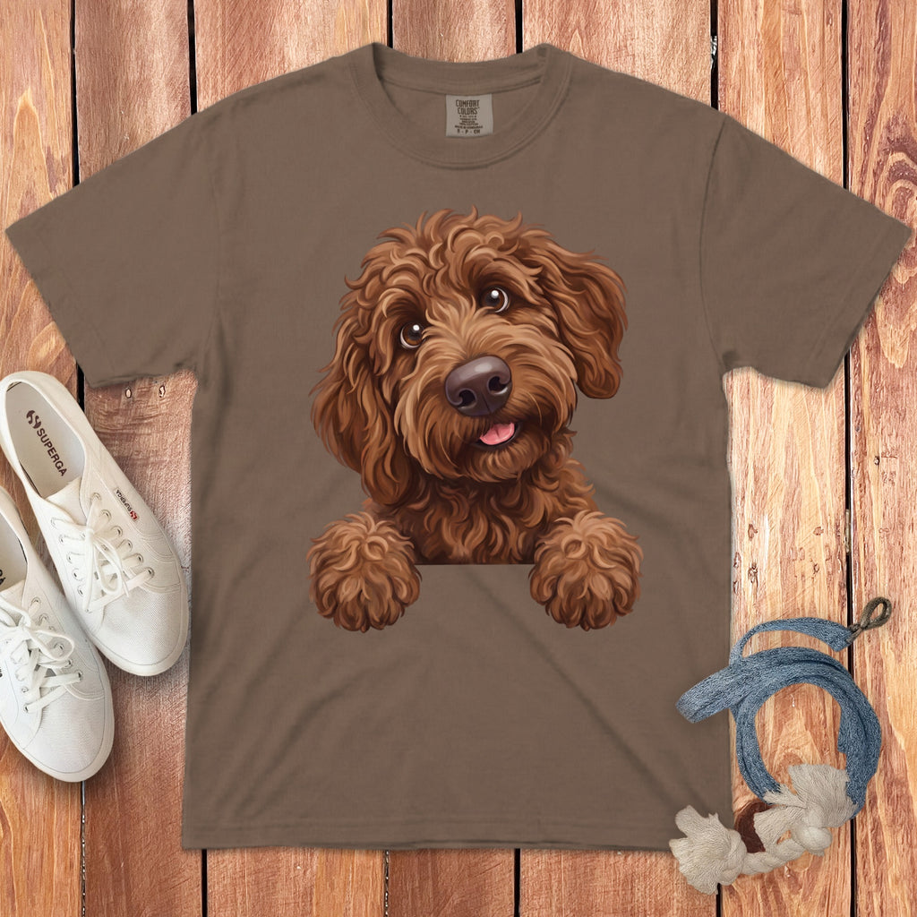 Brown t-shirt with a fluffy brown dog peeking over the pocket area.