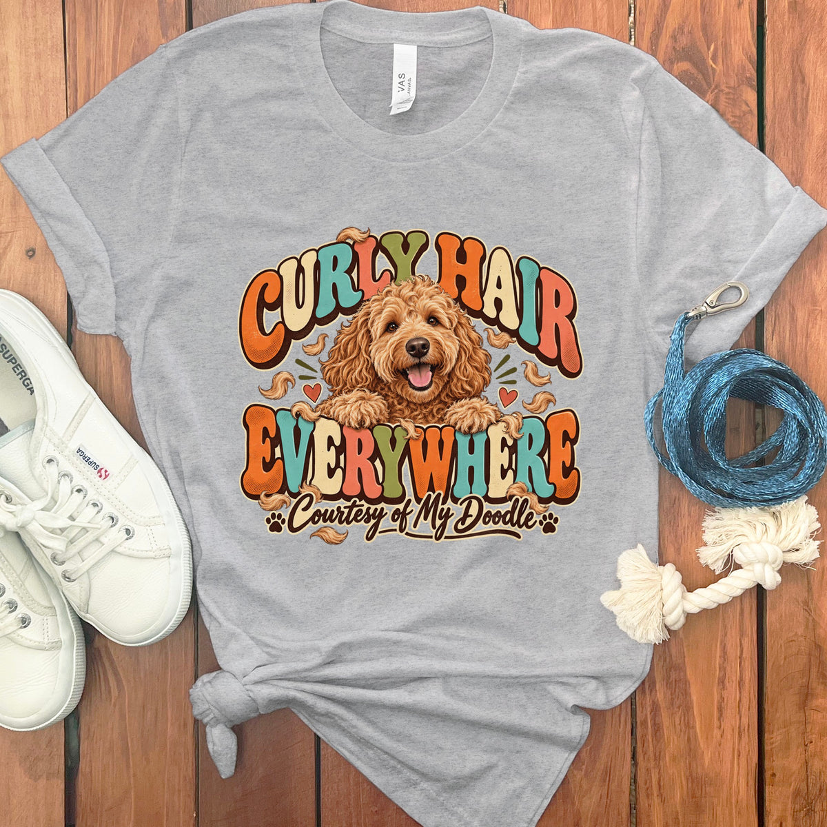 Gray t-shirt with a doodle dog graphic and text "Curly Hair Everywhere Courtesy of My Doodle".