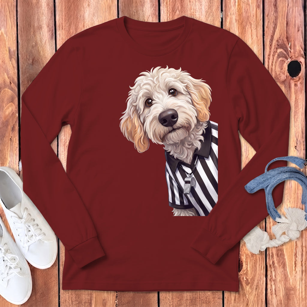 Goldendoodle dog wearing a referee shirt and whistle on a maroon long-sleeve shirt.