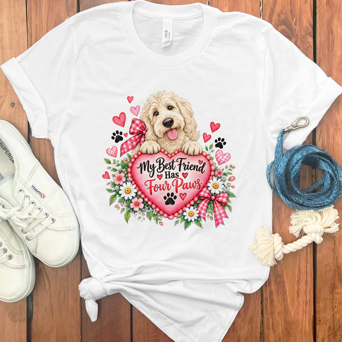 White t-shirt featuring a doodle dog graphic, red heart, and the text My Best Friend Has Four Paws.