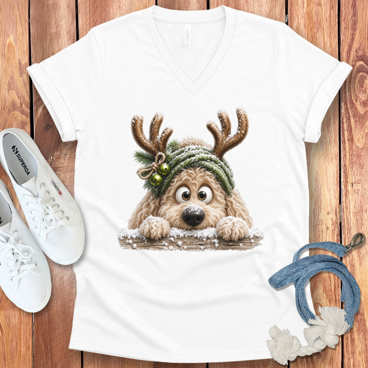 White t-shirt with a cartoon dog wearing reindeer antlers and a green hat.