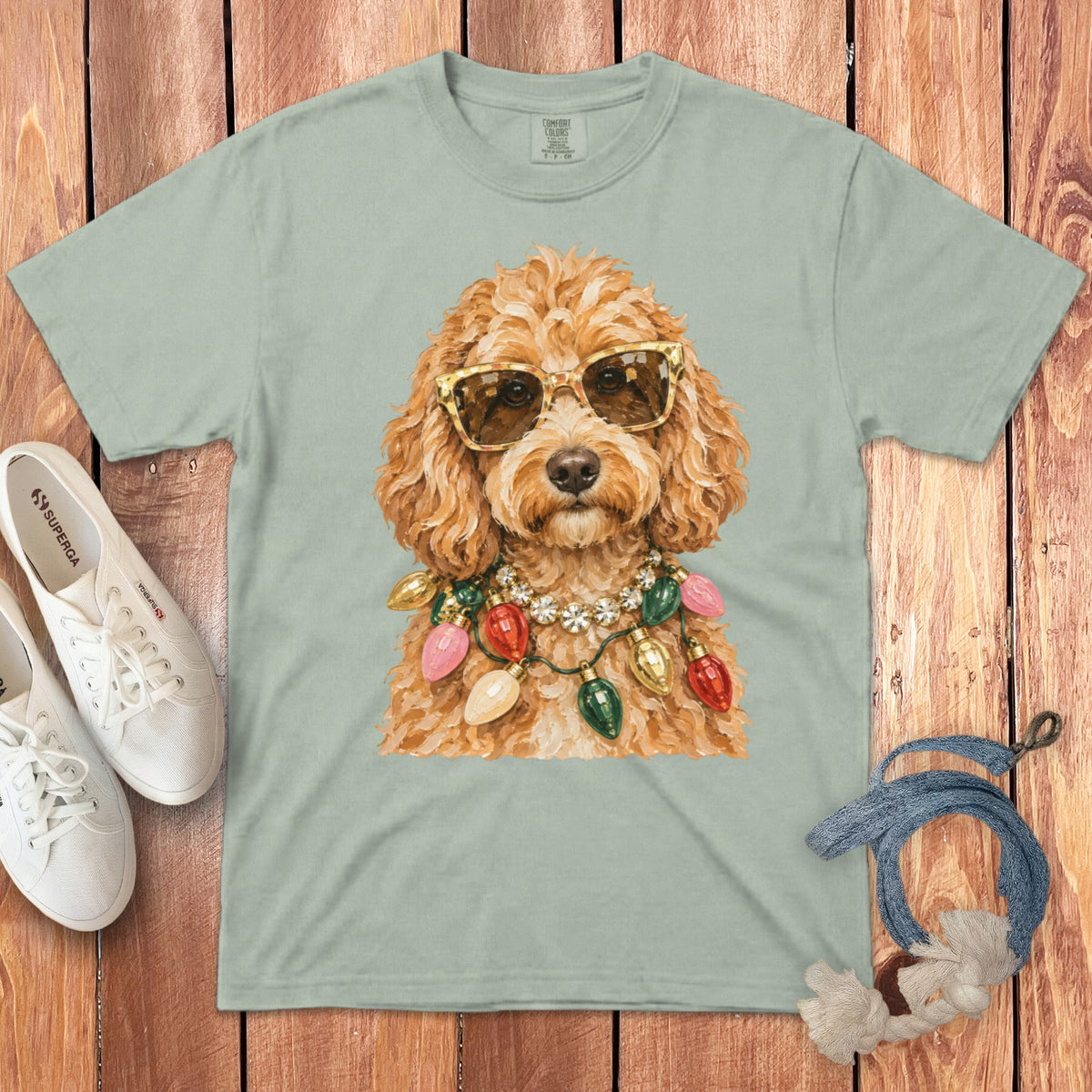 Light green t-shirt featuring a doodle dog wearing sunglasses and a string of Christmas lights.