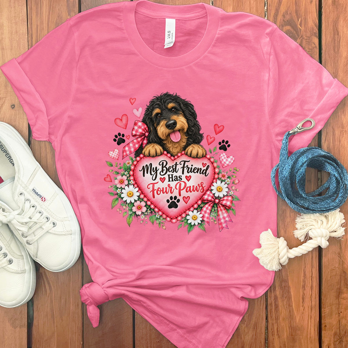 Pink t-shirt with a graphic of a dog holding a heart that reads My Best Friend Has Four Paws.