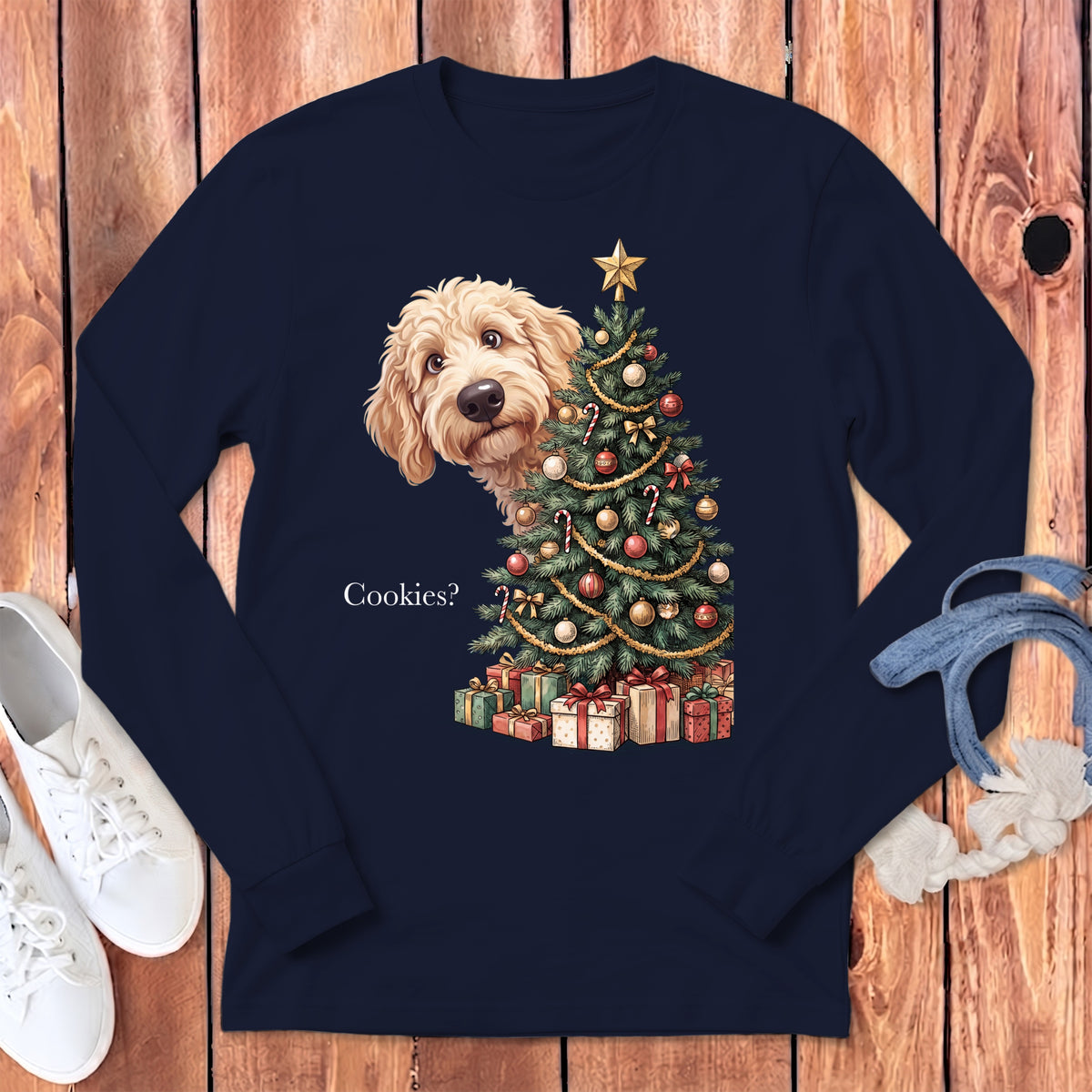 Goldendoodle peeking from behind a Christmas tree and gifts with text "Cookies?".