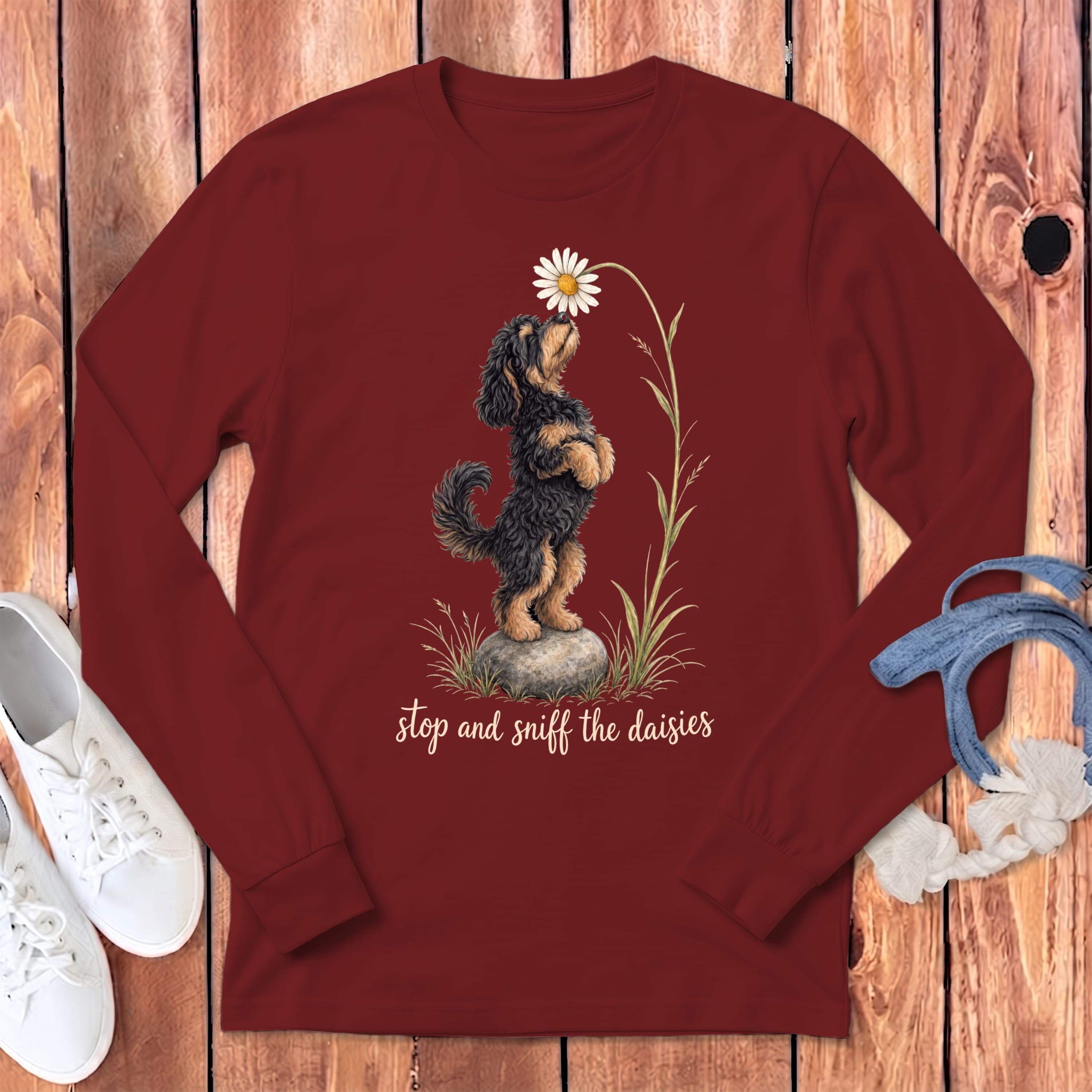 Maroon long-sleeve shirt with a dog sniffing a daisy graphic and text.