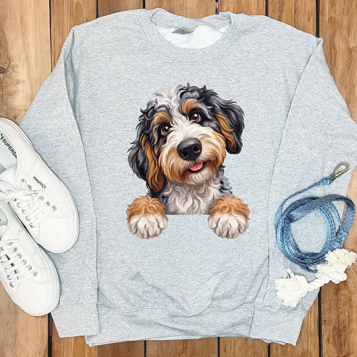 Light gray sweatshirt with a printed bernedoodle puppy peeking over the front.
